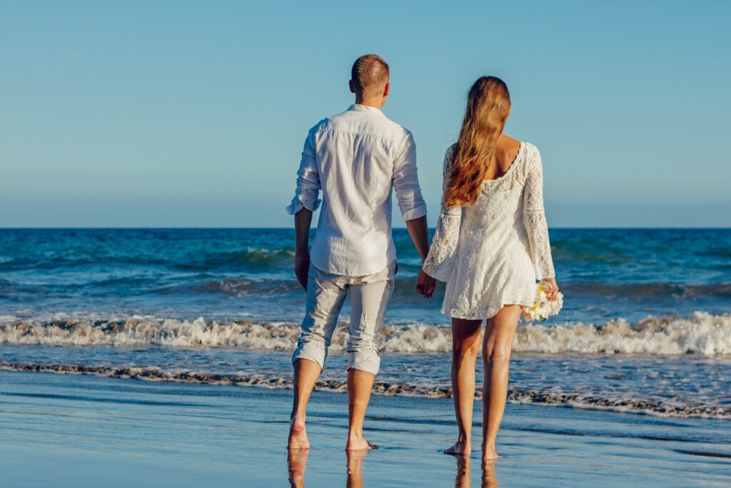 Couple holding hands on beach 